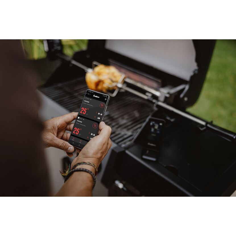 Person grillt Hähnchen und benutzt Thermometer