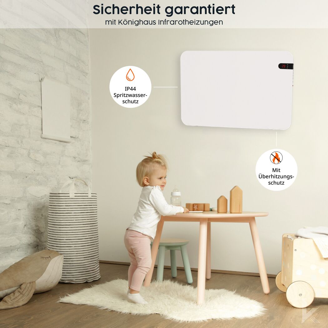 Kleinkind steht an einem Tisch. An der Wand hängt eine weiße Infrarotheizung.