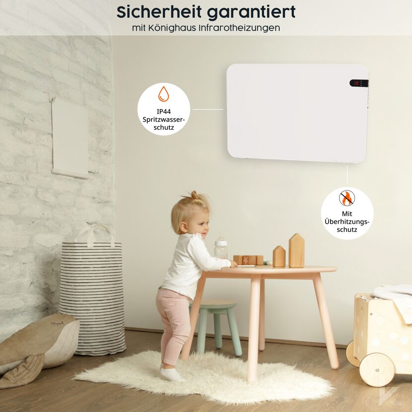 Kleinkind steht an einem Tisch. An der Wand hängt eine weiße Infrarotheizung.