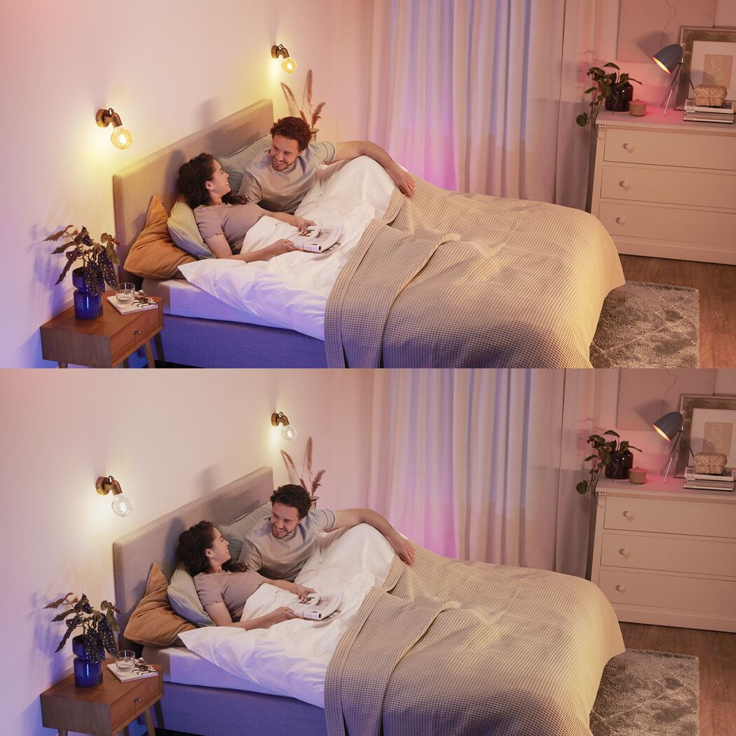 Paar entspannt im Bett mit warm leuchtenden Vintage LED Lampen.
