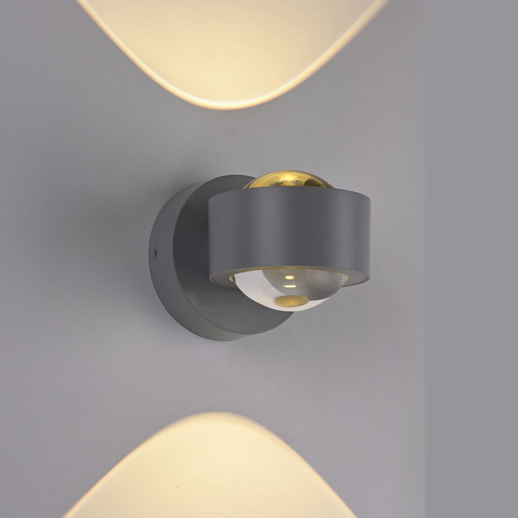 LED-Spot 'Chia' leuchtet warmes Licht an grauer Wand.