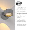 Grauer LED-Spot 'Chia' beleuchtet Wand warmweiß.