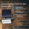 Xsolar L-S ONE Solarleuchte anthrazit an Ziegelwand.