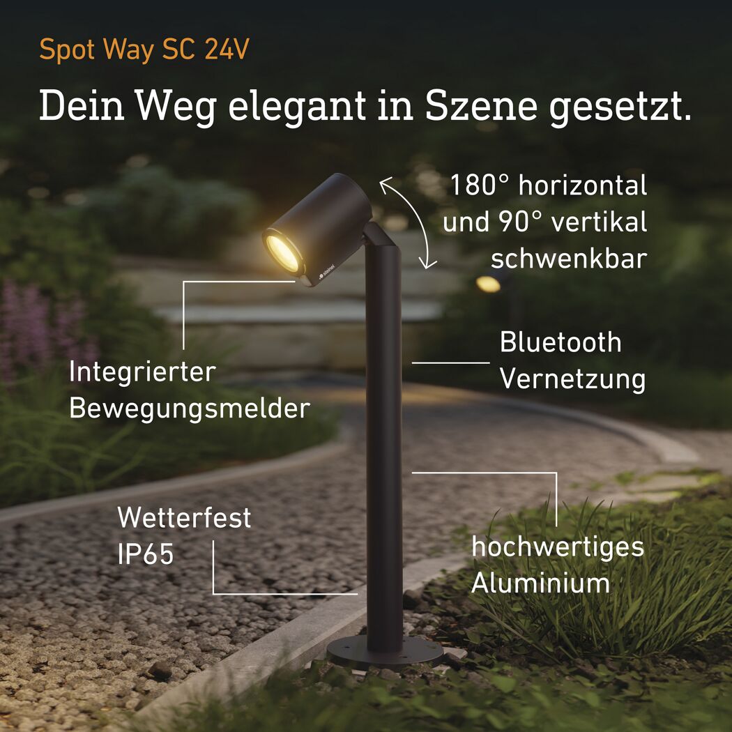 Anthrazitfarbener Strahler 'Spot Way SC 24V' beleuchtet einen Weg.