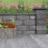 Mauerstein 'T-Wall System' quarzit als Gartenmauer mit Blumenbeet.
