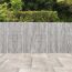 Granitfarbene Palisade 'T-Gravity Shine' mit Pflanzen und Bodenfliesen.