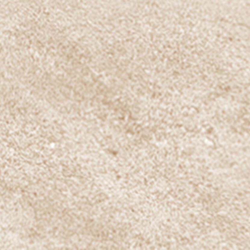 Detailaufnahme sandfarbener, unregelmäßiger Oberfläche.