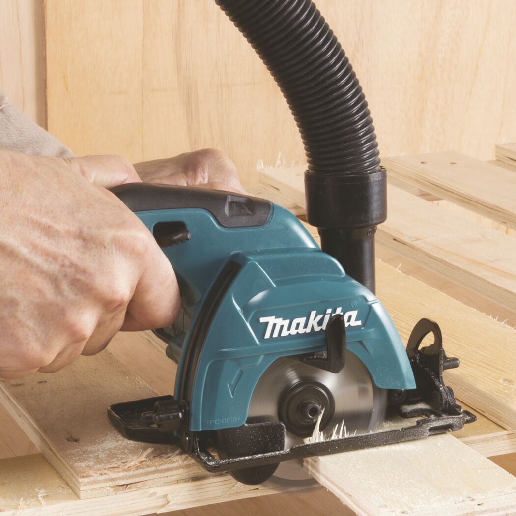 Person sägt mit Makita Handkreissäge ein Holzbrett.