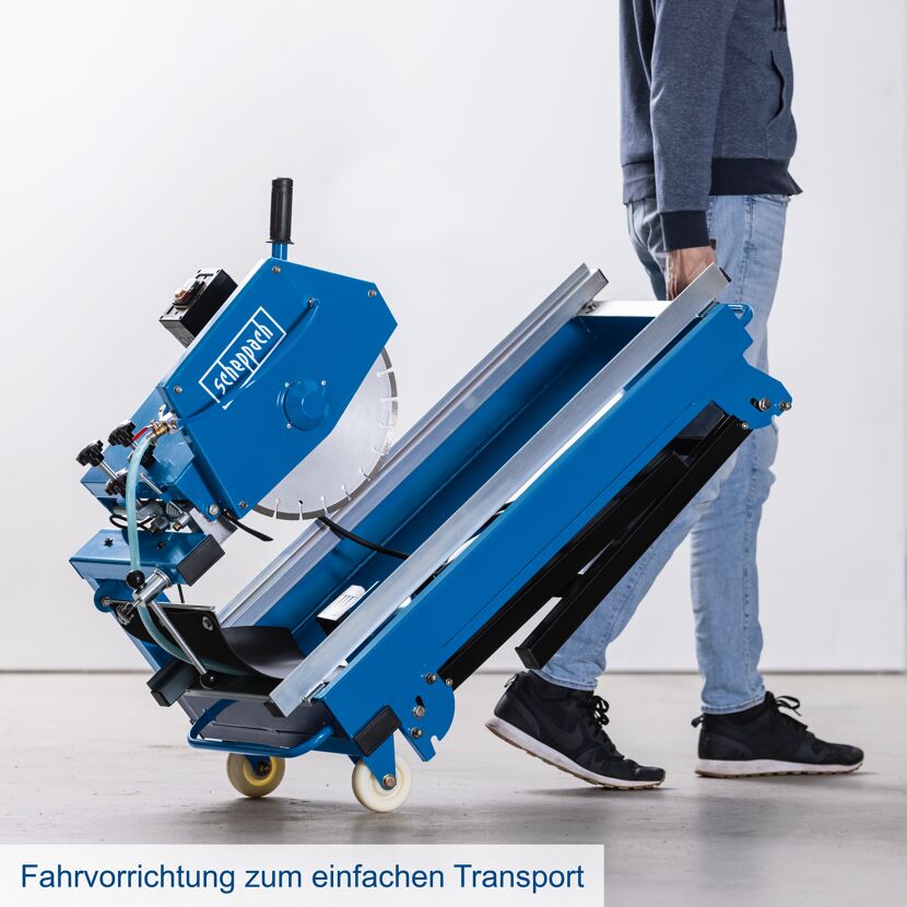 Person transportiert eine Steintrennmaschine.