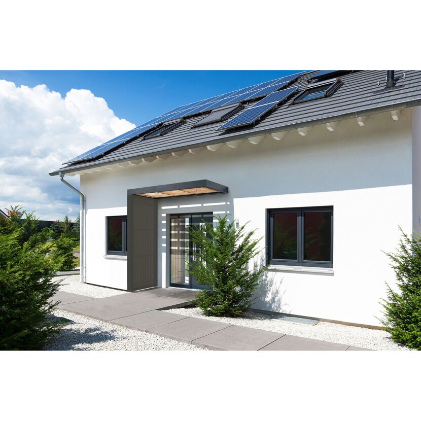 Weißes Haus mit Solarzellen auf dem Dach und Vordach