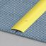 Goldene Teppichleiste auf blauem Teppich und Betonboden.