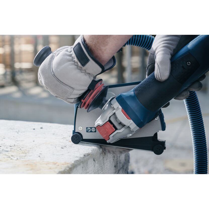 Person schneidet Betonkante mit einem Winkelschleifer