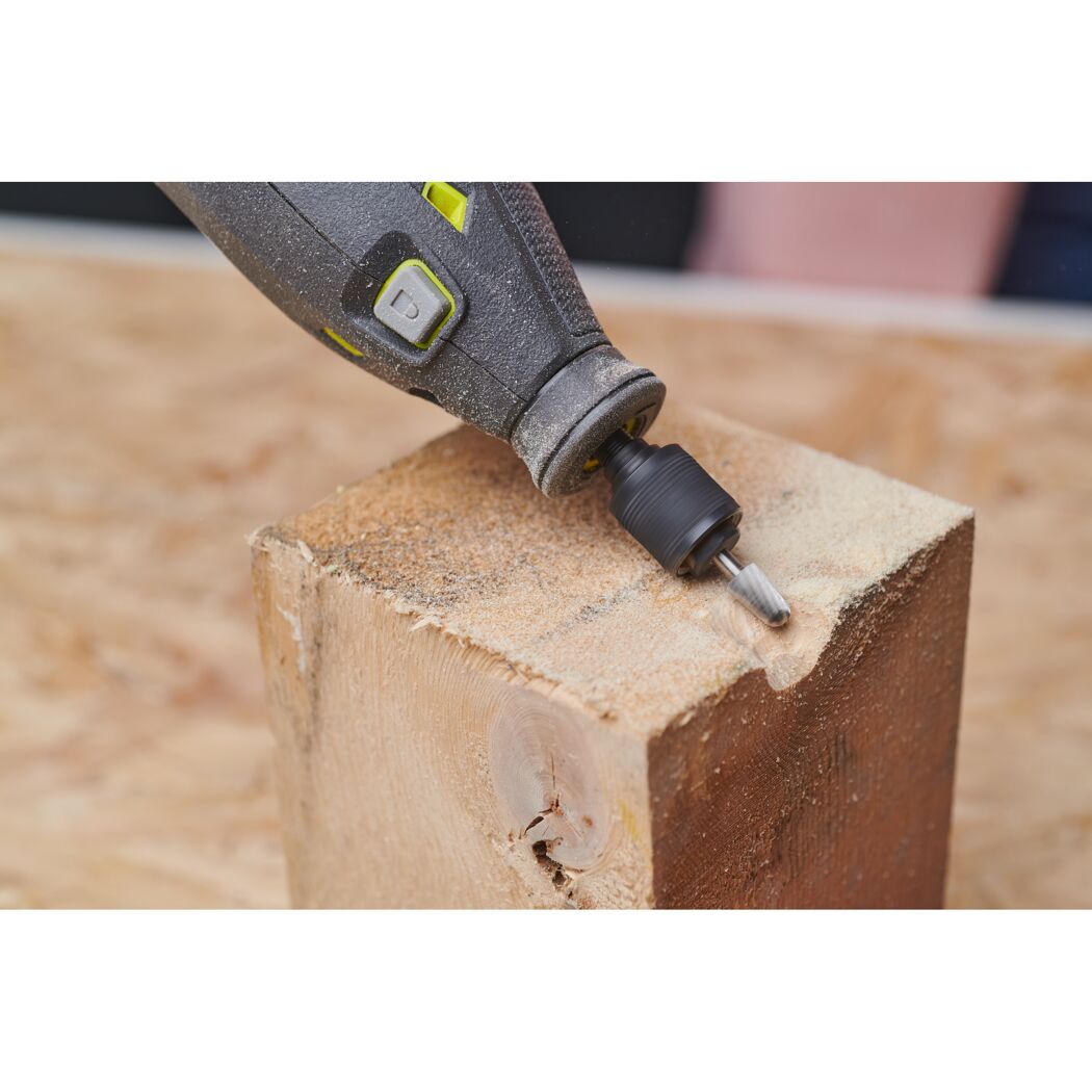 Person fräst mit Multitool in Holz