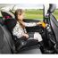 Kind im Autositz trinkt