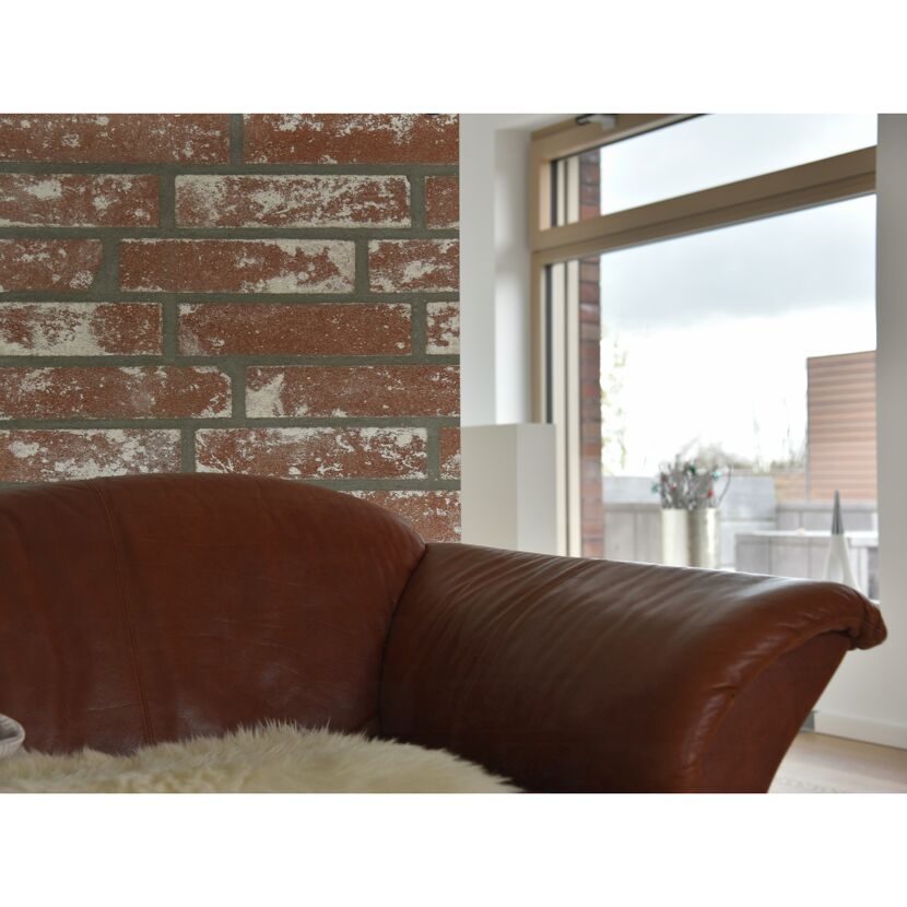 Ledersofa vor Backsteinwand