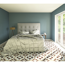 Schlafzimmer mit gemustertem Fliesenboden und Bett