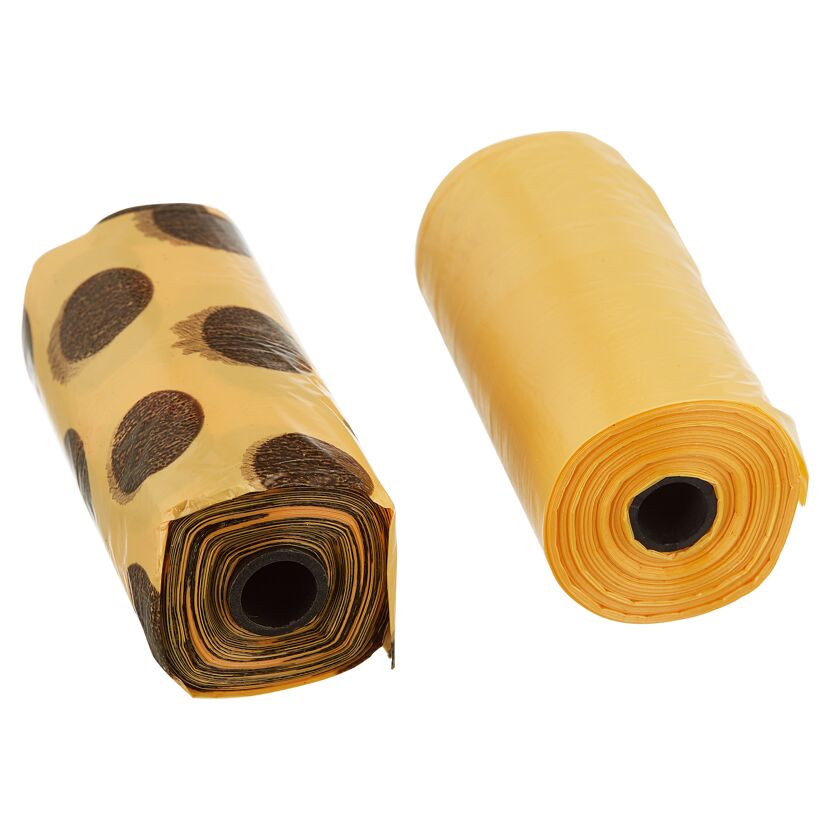 Zwei Rollen Kottüten, eine gelb und eine gelb mit braunen Punkten.