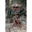 Vogelhaus auf drei Beinen im Wald