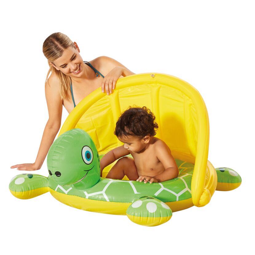Baby sitzt in einem aufblasbaren Babypool in Schildkrötenform.