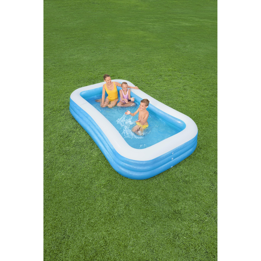 Mutter und zwei Kinder planschen im aufblasbaren Pool.