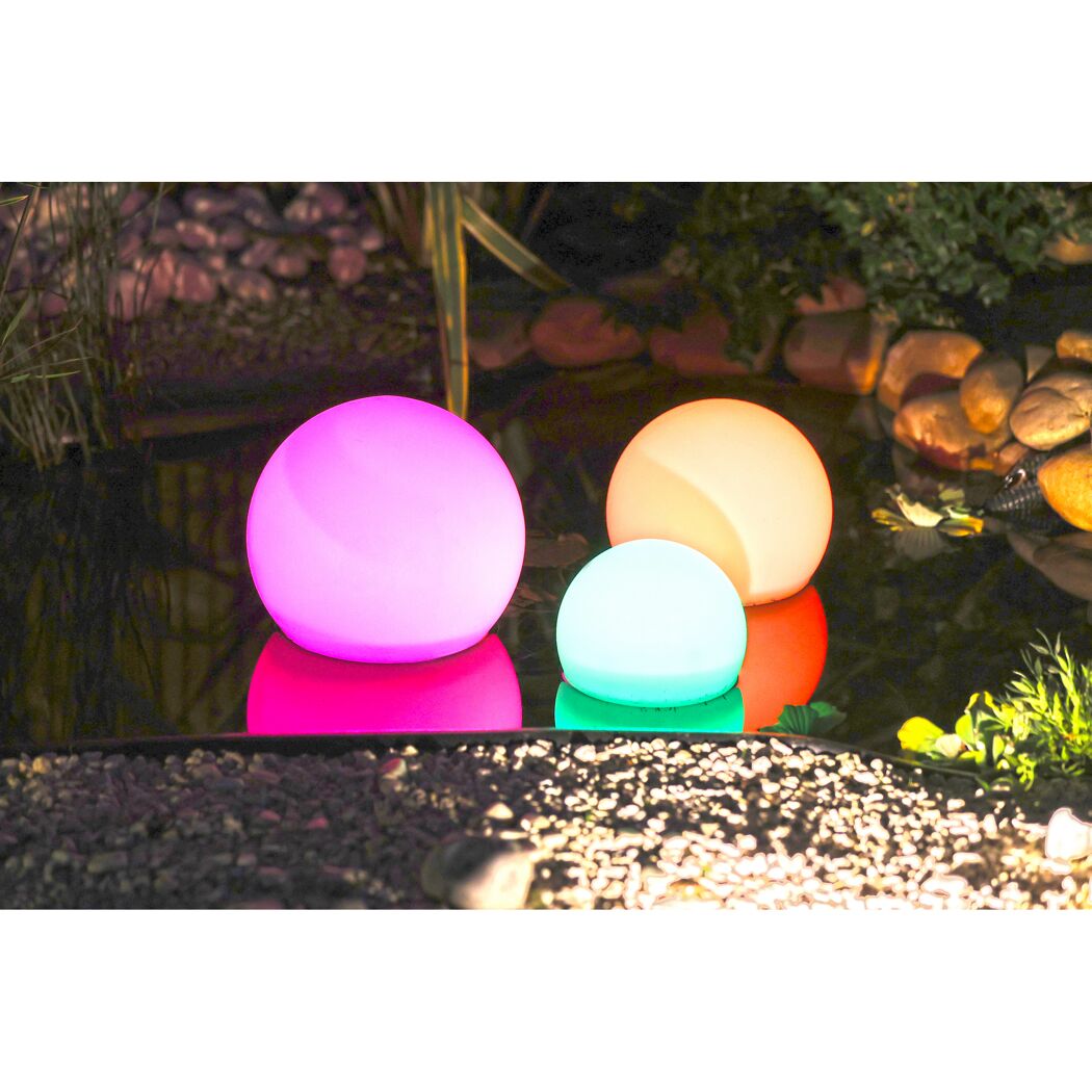 Drei leuchtende Kugeln in Pink, Orange und Türkis