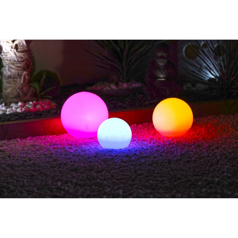 Drei leuchtende Kugeln in Pink, Weiß und Orange
