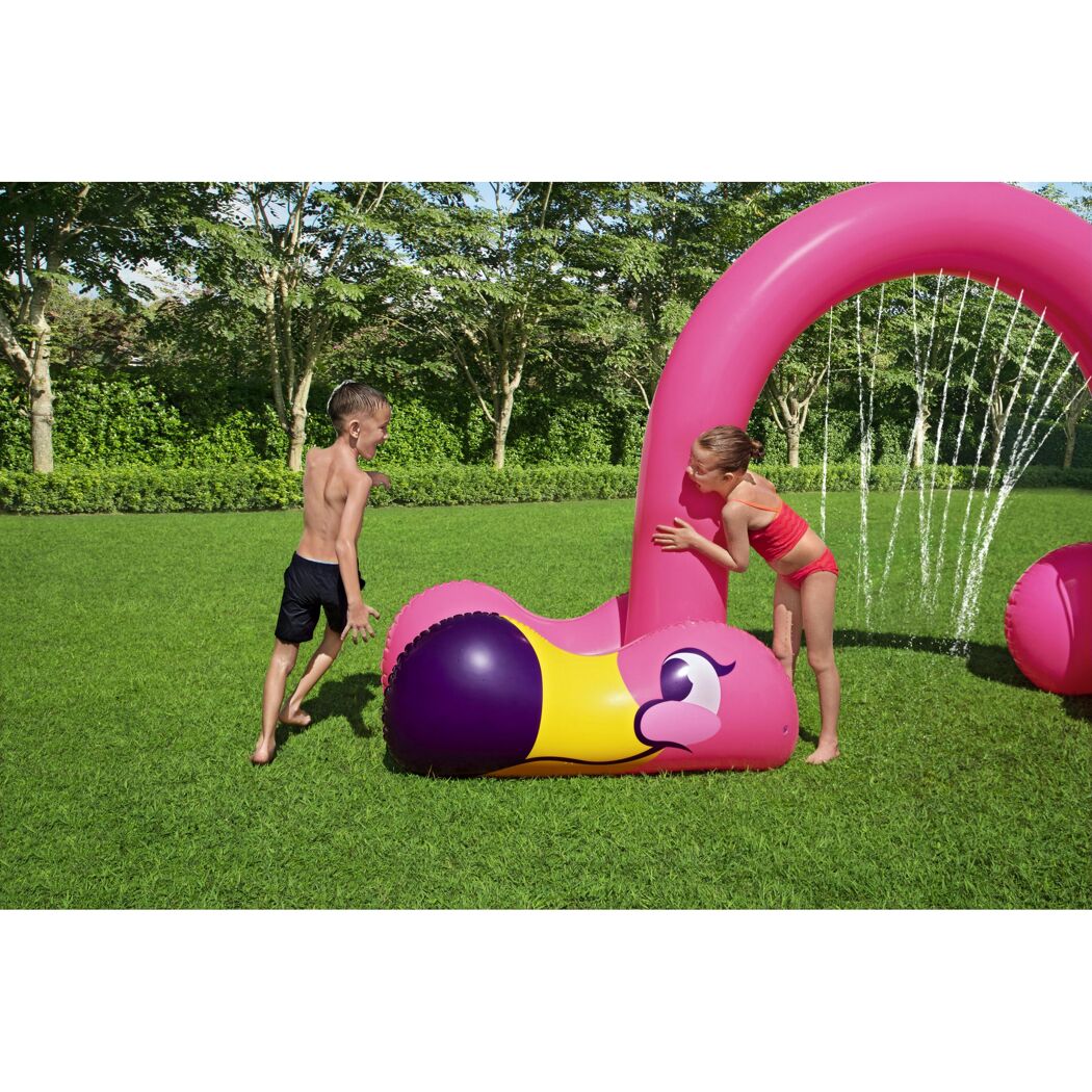 Zwei Kinder spielen mit einem aufblasbaren Wassersprinkler in Flamingo-Form.