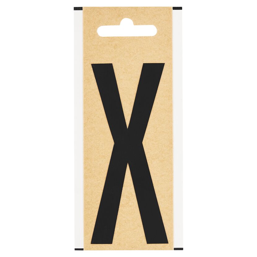 Schwarzer Folienbuchstabe X auf braunem Karton