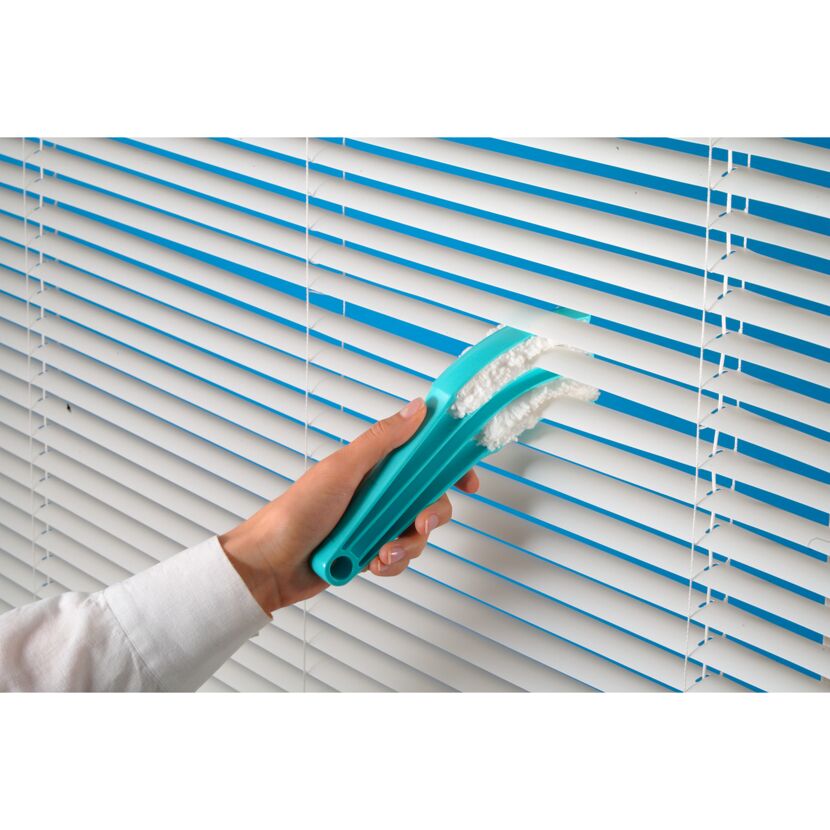 Person reinigt Jalousien mit Jalousienreiniger