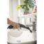 Person reinigt Waschbecken mit Dampfreiniger