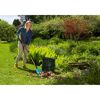 Person verwendet Combisystem-Schaufelrechen im Garten.