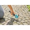 Person entfernt Unkraut mit Fugenkratzer.