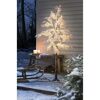 Beleuchteter künstlicher Baum mit Schnee-Effekt im Freien