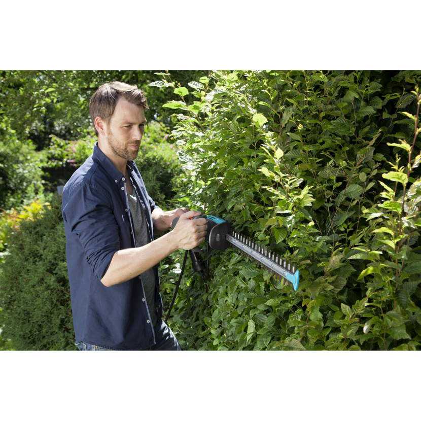 Person schneidet Hecke mit Elektro-Heckenschere EasyCut 500/55