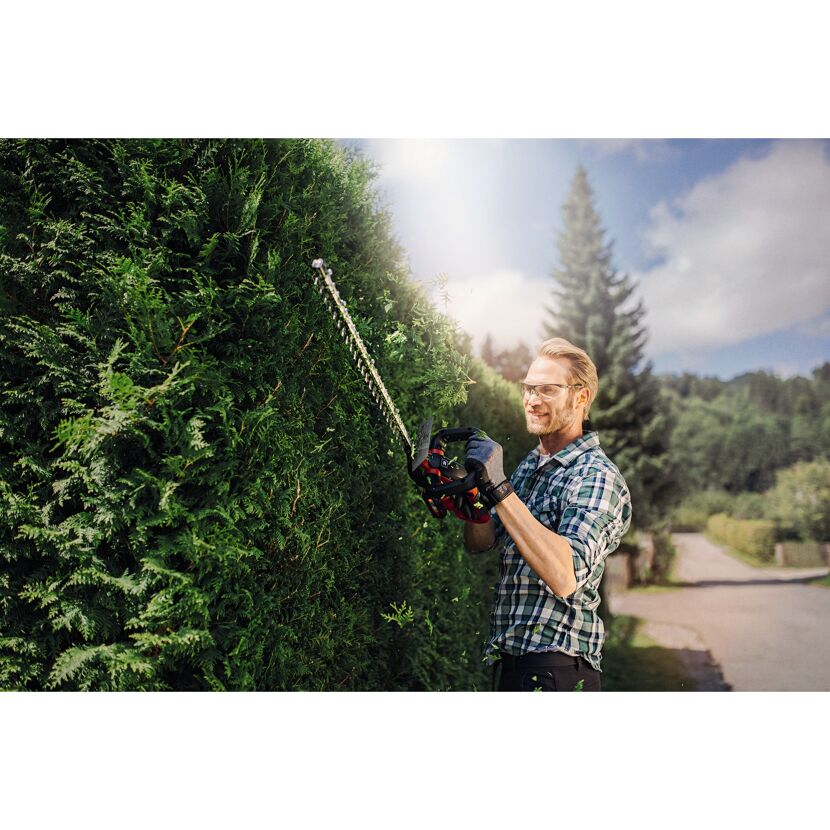 Person schneidet Hecke mit Akku-Heckenschere