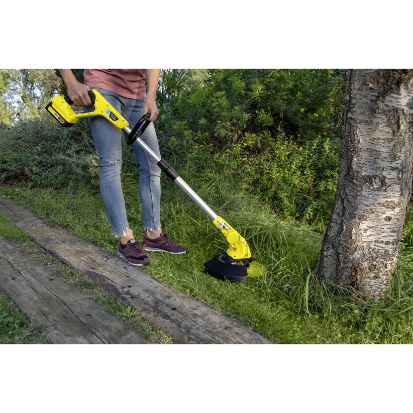 Person schneidet Gras mit einem gelben Rasentrimmer.