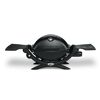 Schwarzer Weber Q1200 Gasgrill mit ausgeklappten Seitentischen.