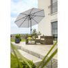 Terrasse mit Sonnenschirm, Lounge-Möbeln und Tisch.