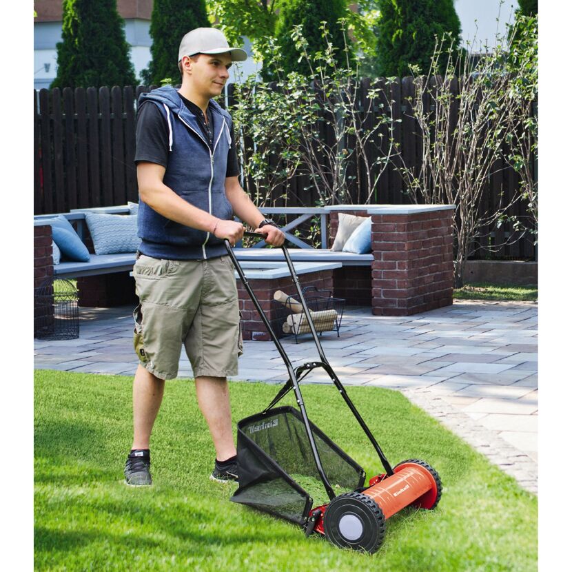 Person mäht Rasen mit Spindelmäher