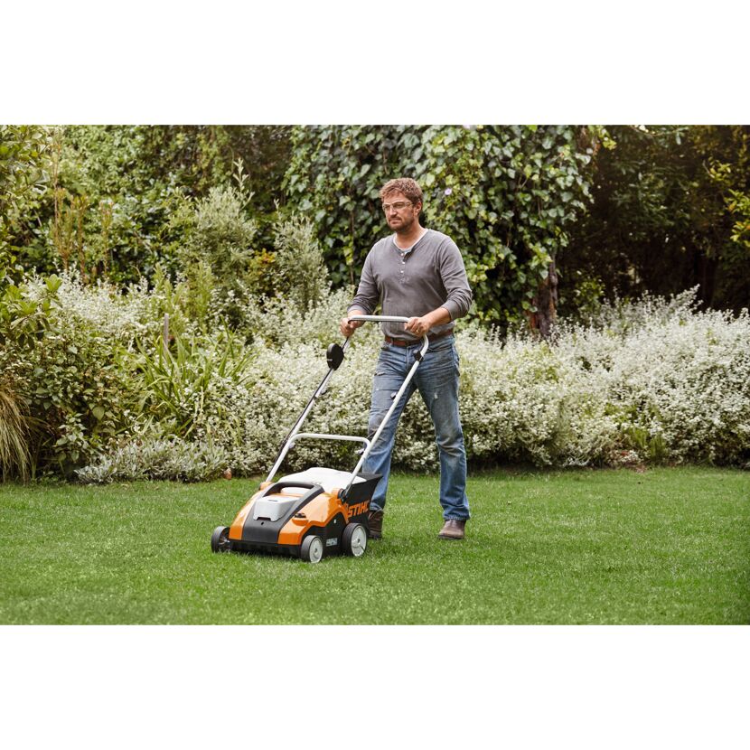 Person vertikutiert Rasen mit STIHL Akku-Vertikutierer RLA 240