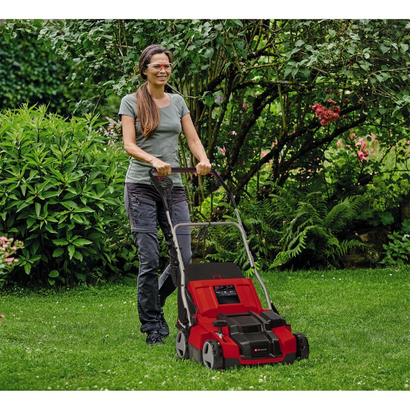 Person vertikutiert Rasen mit Einhell Vertikutierer