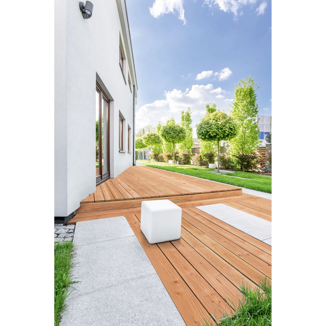 Holzterrasse neben Haus mit Garten