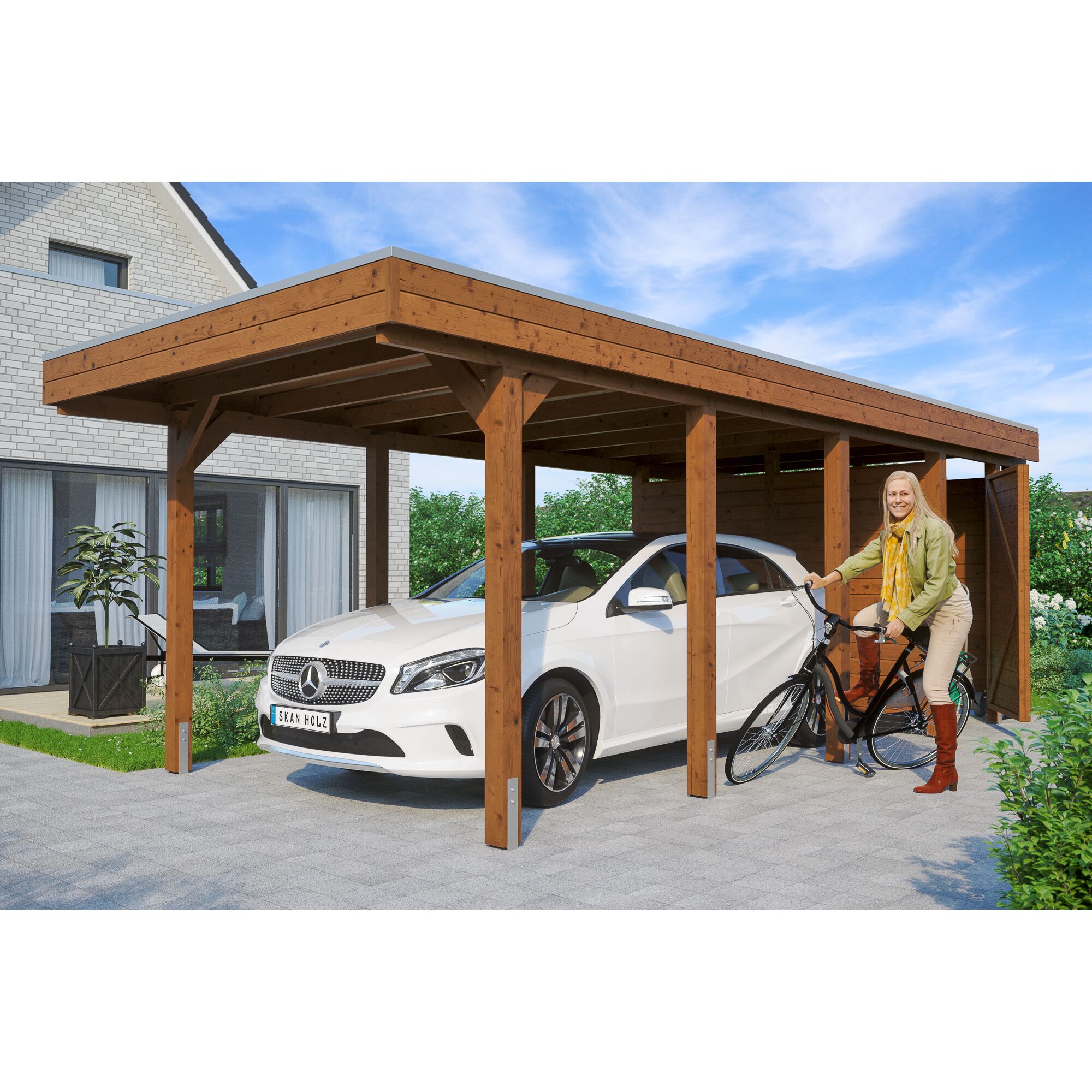 Person schiebt Fahrrad unter einen Carport.