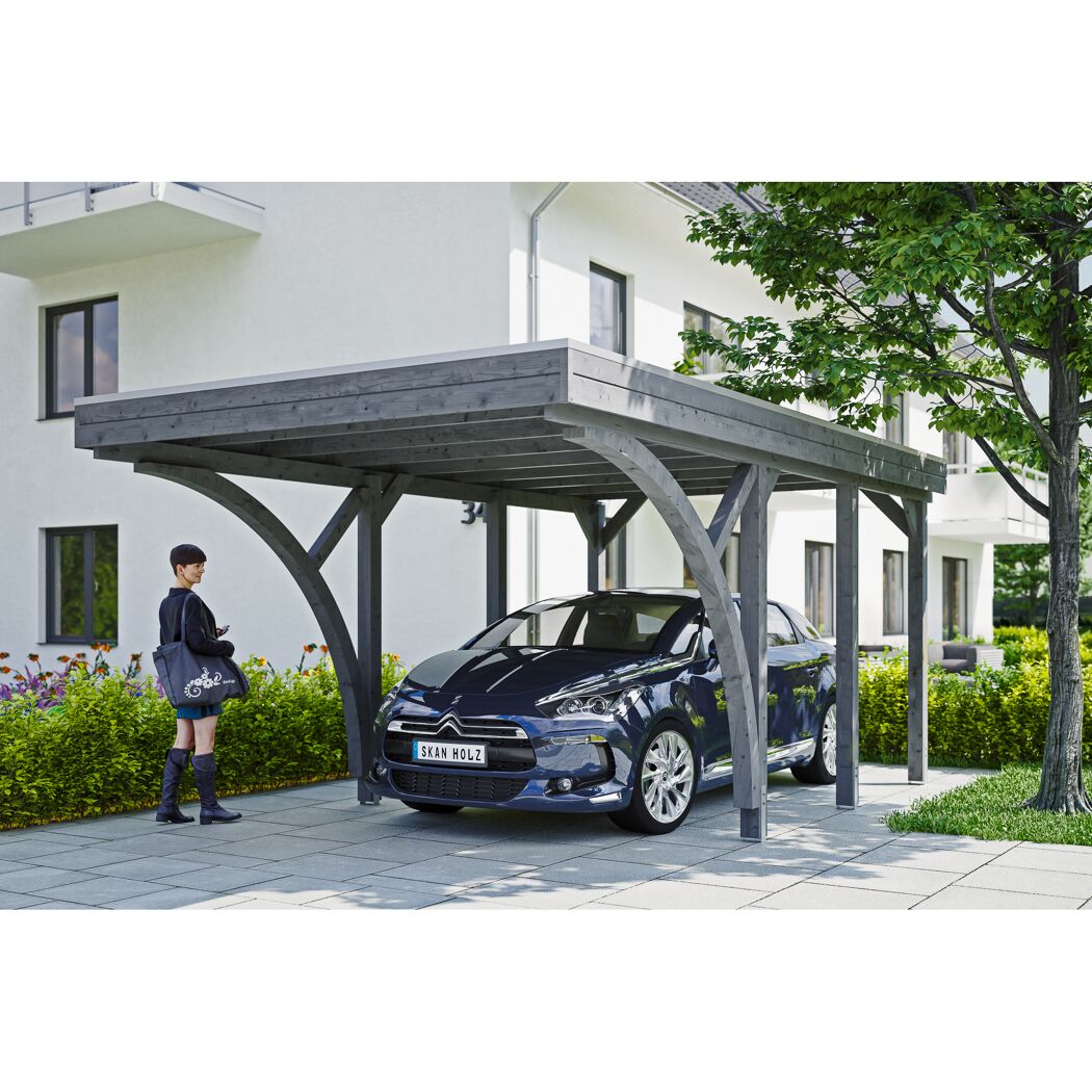 Auto steht unter einem grauen Carport.