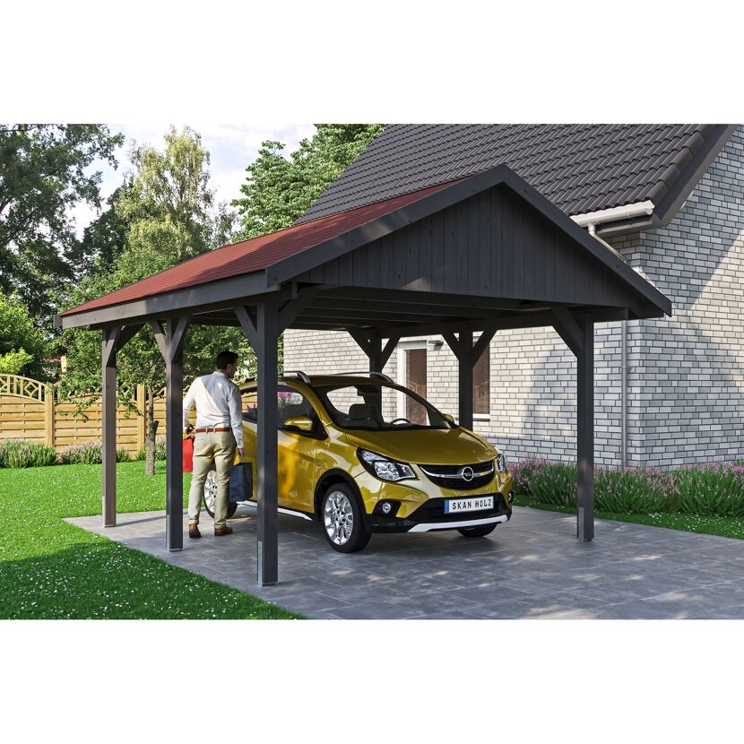 Person parkt goldenes Auto unter Carport