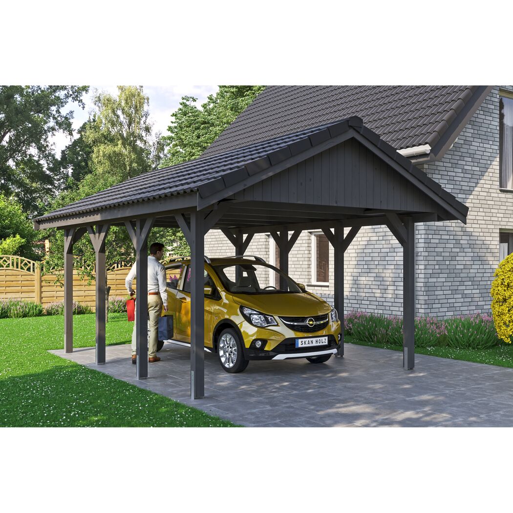 Person parkt gelbes Auto unter einem schwarzen Carport.