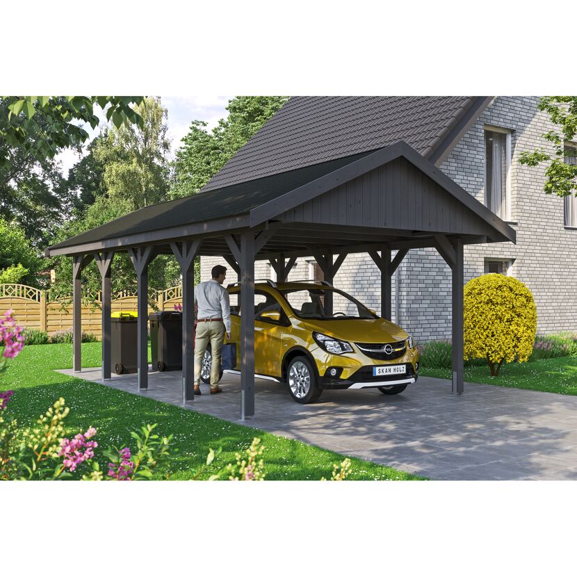 Person parkt gelbes Auto unter Carport
