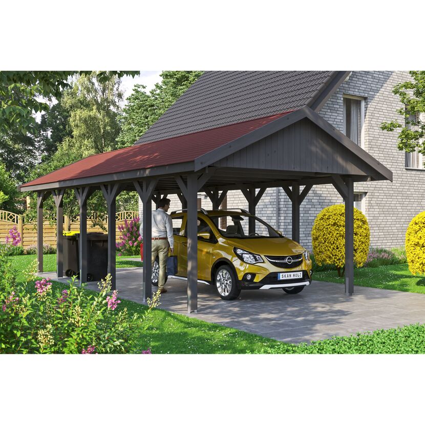 Auto steht unter einem grauen Carport.