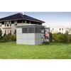 Person schiebt Fahrrad in graues Gartenhaus Sydney