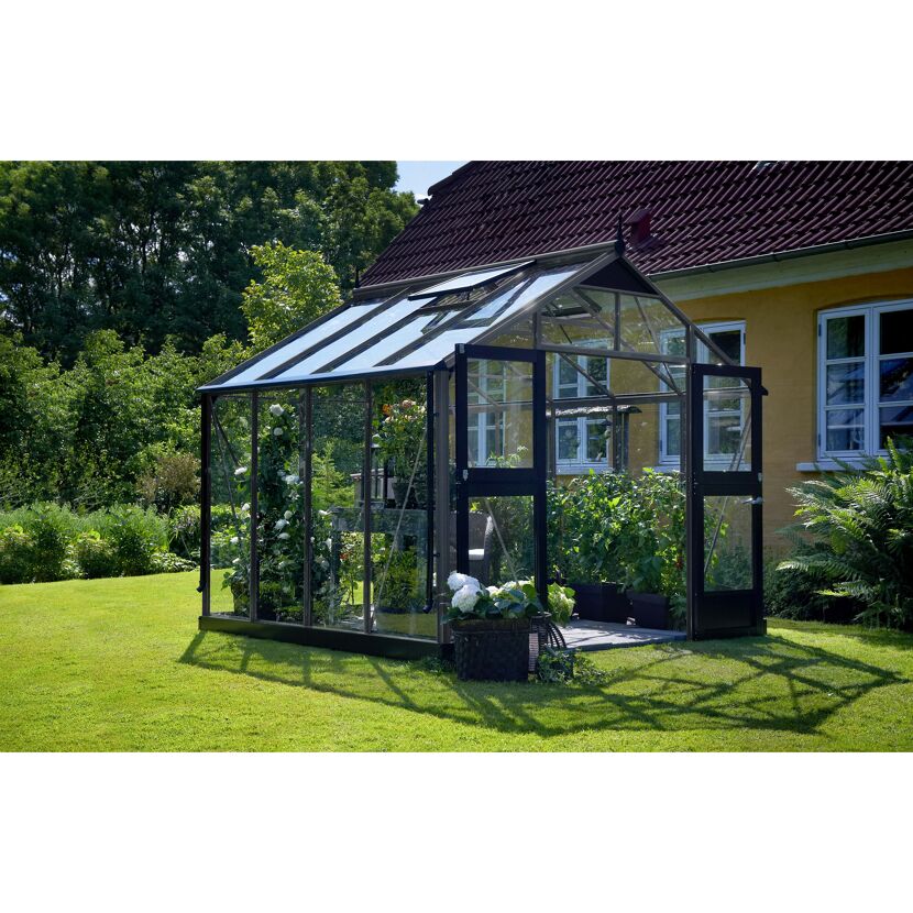 Gewächshaus mit geöffneter Tür im Garten